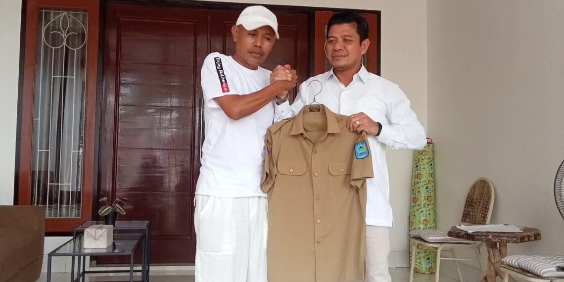 📷 Saat menerima baju keki dari Bupati Dompu, terpancar senyum terpendam dari Some (kiri). Dia memperlihatkan wajah yang polos padahal sedang bermain lakon, kata Boy Ikhwayuddin. (Ist).